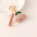 Pink rhinestone cherry keychain with green crystal leaves and matching studded strap - Champagne
