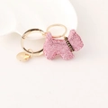 Pink rhinestone puppy keychain with golden clasp and heart detail on white background - Pink