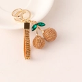 Sparkling champagne rhinestone cherry keychain with green gem leaf and gold lobster clasp - Brown