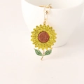 Porte-clés tournesol scintillant avec strass colorés sur une base dorée élégante - Jaune