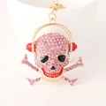 Rosa Strass Totenkopf Schlüsselanhänger mit roten Kopfhörern und goldener Beschichtung - Rosa