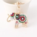 Gouden olifant sleutelhanger met kleurrijke strasstenen en emaille bloemen - Wit + Paars