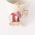 Portachiavi a elefante dorato con smalto rosso e cristalli rosa su sfondo ceramica - Rosso