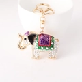 Golden elephant keychain with crystal rhinestones and purple enamel floral accents - White