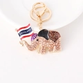Golden elephant keychain with brown rhinestones and Thailand flag on white background - Champagne
