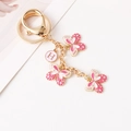 Roze emaille vlinder sleutelhanger met gouden afwerking en letter H hanger - Roze