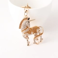 Goldener Einhorn Schlüsselanhänger mit weißen und champagnerfarbenen Kristallen - Gelb