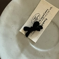 Close-up of black velvet bow hair clip on minimalist card holder for women - Black Little Bow Hair Clip