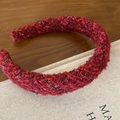 Red tweed knotted headband with silver glitter thread for women on a wooden desk - Red Shiny Striped