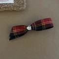 Close-up of British style red and blue plaid bow hair clip with heart-shaped crystal center - Large Long Bow Style