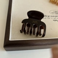 Tortoiseshell acetate hair claw clip with gold lettering in a wooden jewelry tray - Three-Claw Clip / Brown