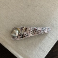 Detail of pink tweed hair clip with textured fabric and polished silver metallic accent - Pink and Black Striped Triangle Hair Clip with Artificial Pearl