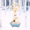 Flying pig keychain with gradient rhinestones and golden wings in a snow forest - Blue & White