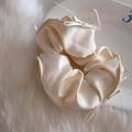 Macro detail of cream satin scrunchie featuring delicate ribbon bows and silky texture - Creamy White Bow Scrunchie