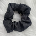 Close-up of a charcoal grey pleated fabric scrunchie with subtle silver glitter on plush background - Gray Stripe Scrunchie