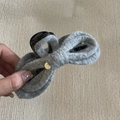Detail of grey knitted bow hair claw clip with golden pendant decoration - Grey Bow Hair Claw