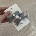 Detail of grey knitted bow hair clips with large white pearls on a display card - Gray Bow Set
