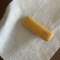 Detailed macro view of glossy yellow resin barrette clip on soft white fabric background - Yellow Square Hair Clip