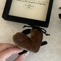 Detail view of brown velvet heart hair clip with small black bow and gold flower charm - Brown Heart Style