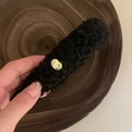 Close-up of black faux shearling hair clip with gold believe engraving plaque - Gold Tag Headband / Black