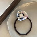 Elegant camellia hair tie with blue pink artistic acetate flower on a ceramic plate - White with Blue Dots Flower