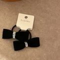 Detailed view of black velvet bow hair ties with pearl accents on a display card - Black Bow Pearl Hair Ties (Set)
