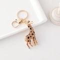 Porte-clés girafe avec strass champagne et émail noir sur une base en métal doré - Champagne Doré