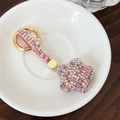 Portachiavi a stella rosa scintillante con strass e placcatura in oro su piatto bianco - Rosa e Bianco