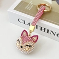 Pink fox keychain featuring sparkling rhinestones and white pearls with gold hardware - Pink