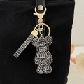 Sparkling silver rhinestone bear keychain charm on black canvas bag with golden hardware - Gun Grey