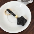 Porte-clés étoile doré exquis orné de strass noirs brillants sur céramique blanche - Noir