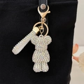 Sparkling crystal bear keychain with colorful rhinestones on a black bag - AB White
