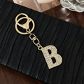 Elegante portachiavi in lega dorata con ciondolo lettera B decorato con strass scintillanti - Lettera B