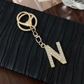 Golden alloy letter N keychain charm with sparkling crystals for bags and accessories - Letter N