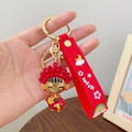 Festive red cartoon mascot keychain with gold ring and red rubber wish wrist strap - Chinese Bride