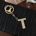 Elegant gold alloy keychain with letter T pendant featuring sparkling crystal rhinestones - Letter T