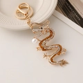 Chinese zodiac dragon keychain with sparkling crystals and pearl in golden finish - Gold