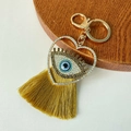 Goldener Herz-Schlüsselanhänger mit blauem Evil Eye und langer gelber Seidenquaste Deko - Gelb