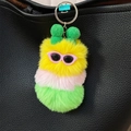 Cute colorful caterpillar plush keychain in pink, yellow and green on a black bag - Yellow