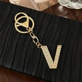 Gold letter V keychain with sparkling rhinestones and lobster clasp on black leather - Letter V