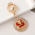 Golden dragon keychain with red rhinestones and circular cutout design for zodiac gift - Red