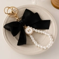 Elegant large black fabric bow keychain with white faux pearls and gold hardware - Black