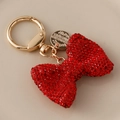 Glitzernder Schlüsselanhänger mit roter Strass-Schleife und goldenem Metallring - Rot