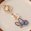 Blue crystal butterfly keychain with gold plating, white pearls and sparkling rhinestones - Blue
