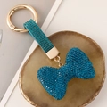 Funkelnder dunkelblauer Strass-Schleifen-Schlüsselanhänger mit goldenem Metallring - Blau