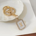 Portachiavi dorato con lettera X in smalto bianco e decorazione con strass - Lettera X