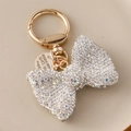 Sparkling crystal bow keychain with gold spring ring and engraved tag in iridescent finish - White
