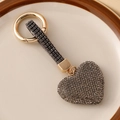 Luxury heart-shaped keychain featuring dark grey rhinestones and golden metal ring - Gray
