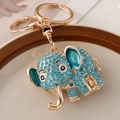 Portachiavi a elefante con strass verde acqua e metallo dorato in un piatto di ceramica - Blu