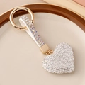 Sparkling white crystal heart keychain with golden finish and full rhinestone setting - White